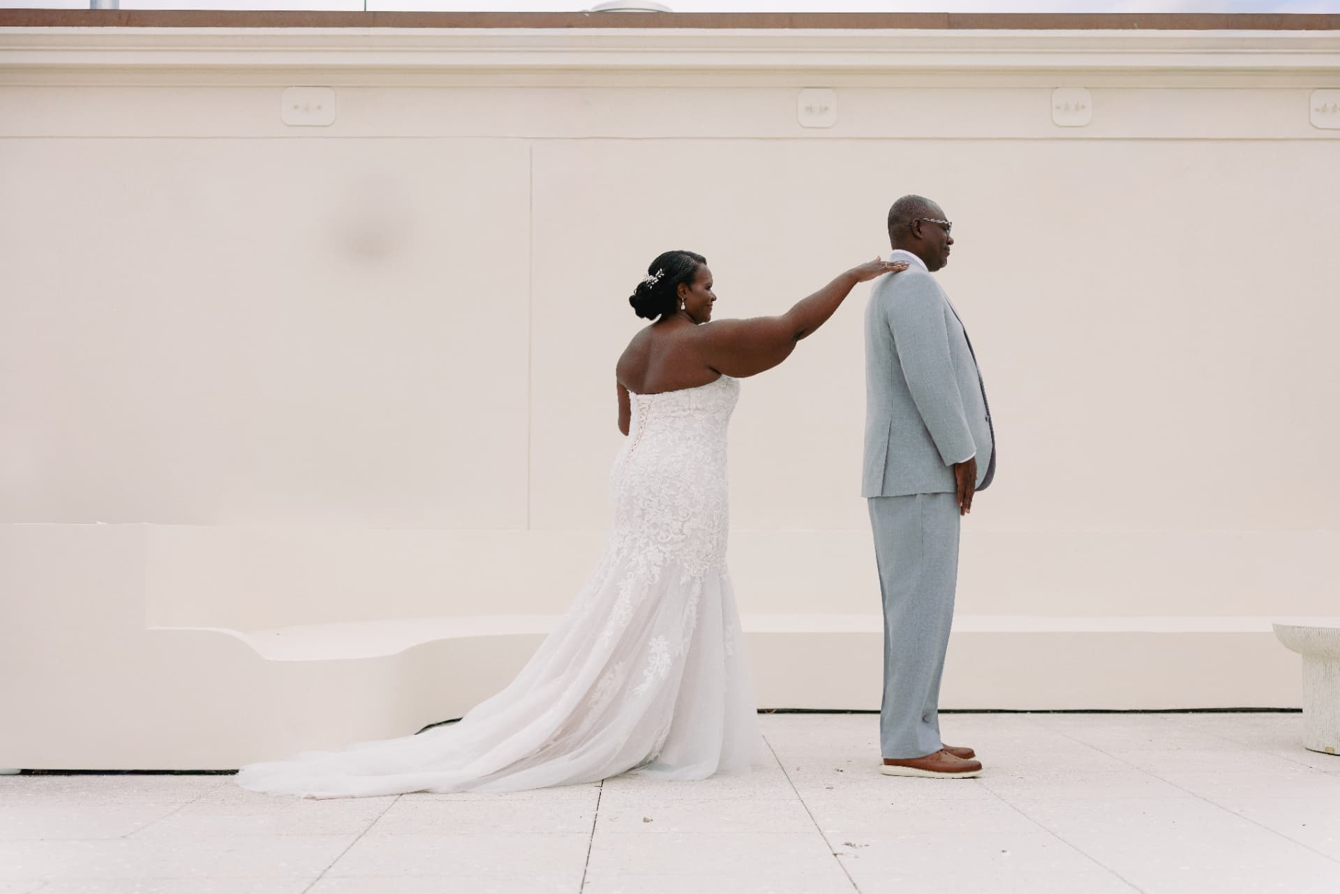 Bride reaching out for a first look with her groom