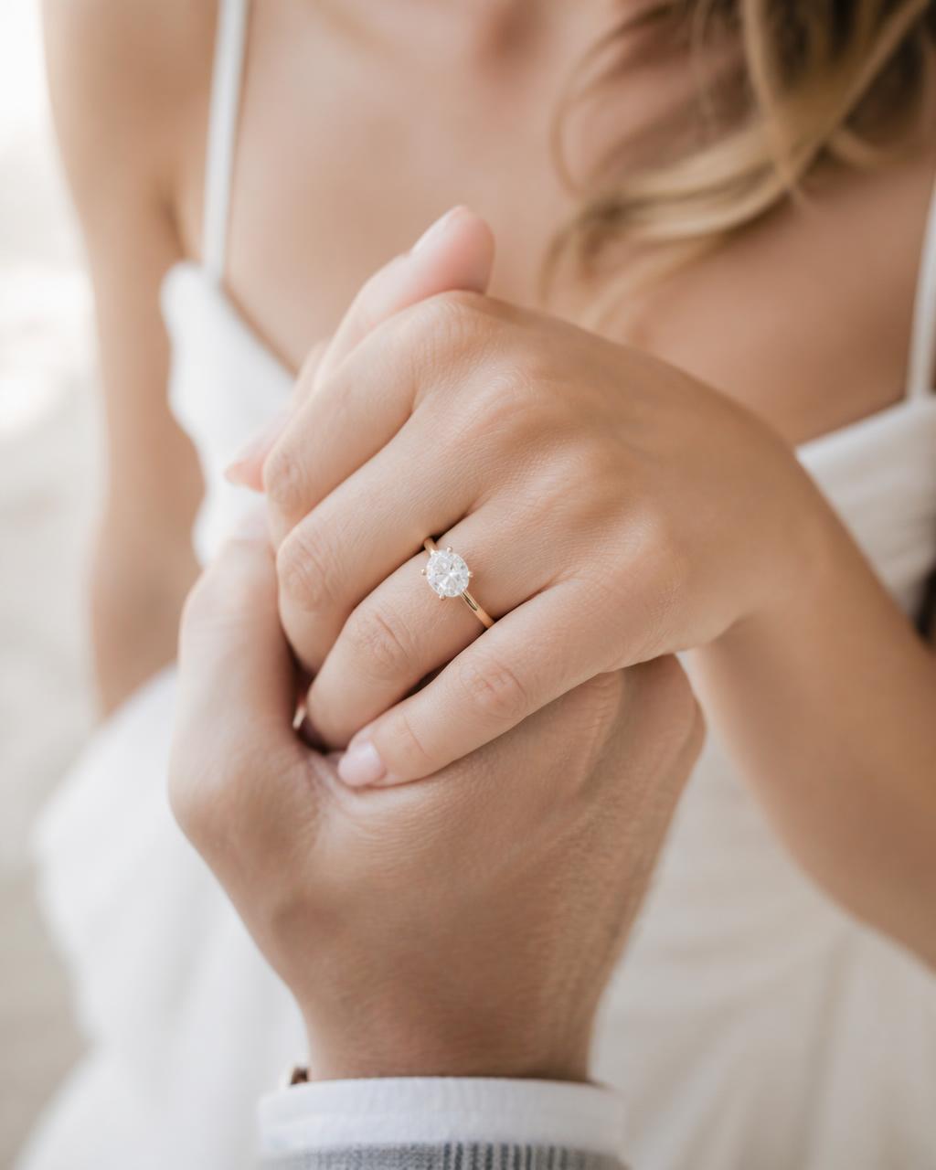 Close-up of the couple's hands and engagement ring